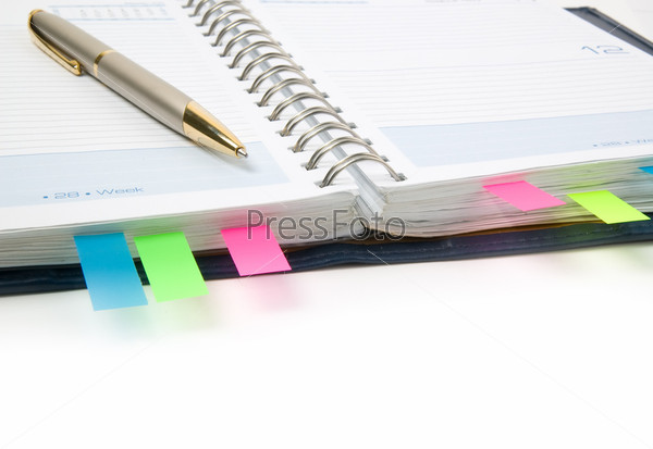Daily planner with colored bookmarks. White background.