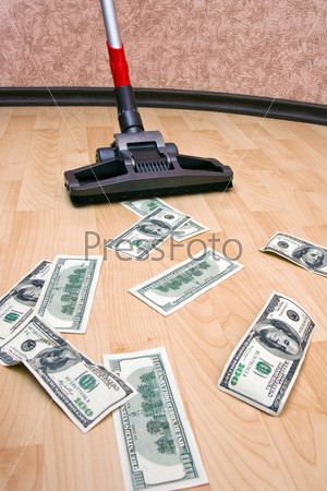 Vacuum cleaner cleaning monetary dust on the floor