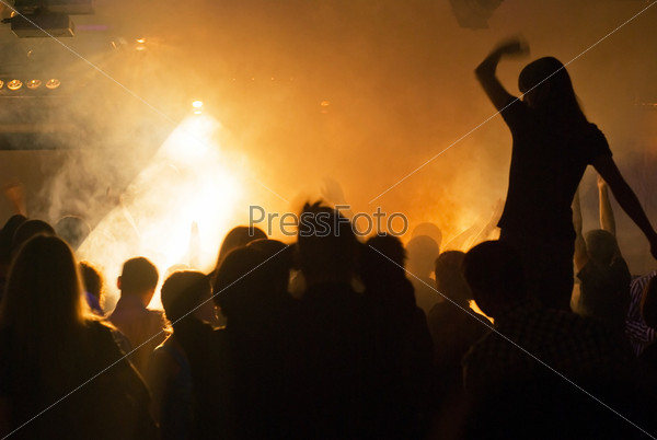 photo of silhouettes against stage lighting at rock concert
