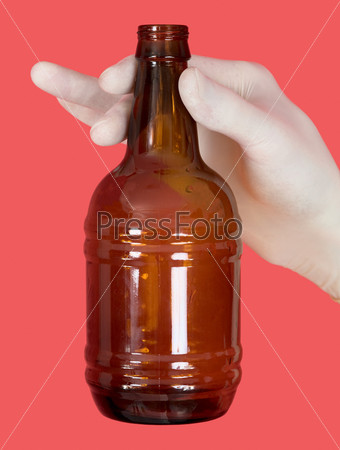 Brown bottle in hand on the red background