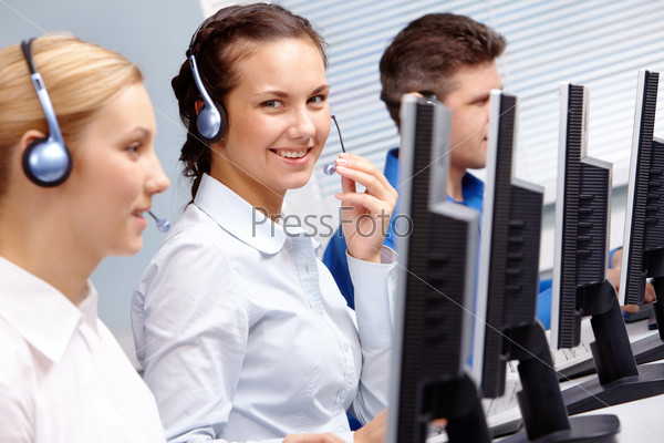Business team of operators sitting at the table during telephone conversation