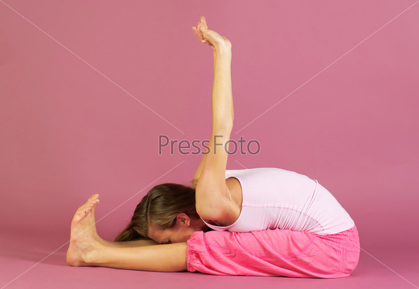 Young beautiful woman in pink practice yoga