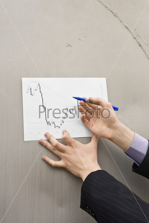 Businessman hands on the barrel background holding marker and prepearing to add chart marks
