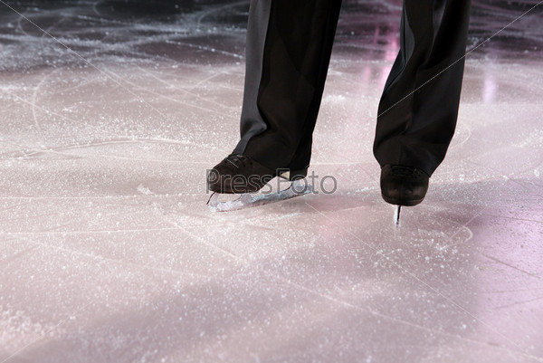 The man figure skater in ice stadium
