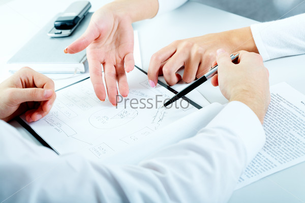 Close-up of business people planning a new project , stock photo