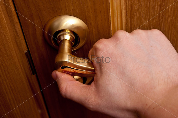 Man hand opening wooden door. Horizontal shot