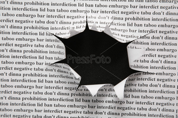 sheet of paper with printing text and cut hole against black background