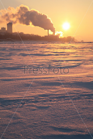Smoke from the pipes above the frozen river 2