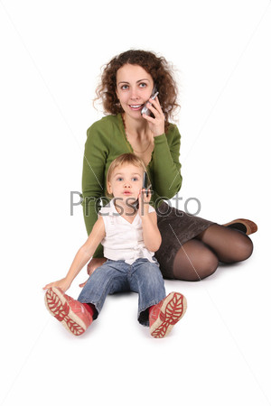 mother and daughter sitting they talk on the cell phones on the the white 2