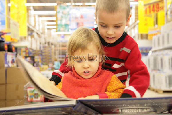 two children look book in  store