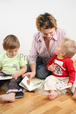 children looking books with mother 2