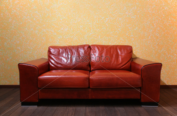 red leather sofa in room ith wood floor