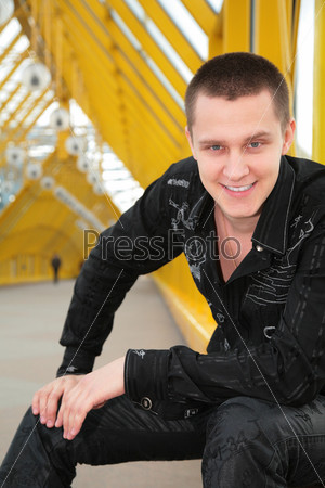 smiling guy on yellow footbridge