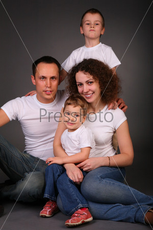 family in studio on dark background