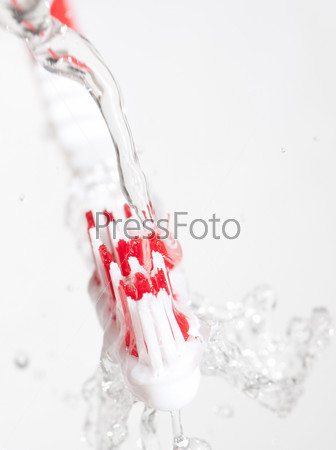 Toothbrush in a water splash, stock photo