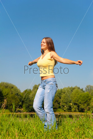 Youmg woman dancing in park