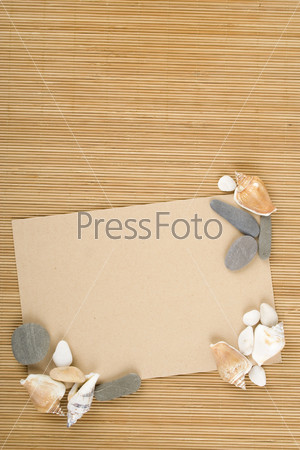 Against the backdrop of an old wooden surface paper with shells. Travel