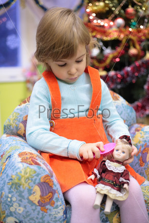 Girl in kindergarten with doll