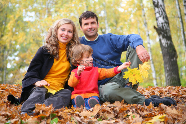 family with little girl in autumn park