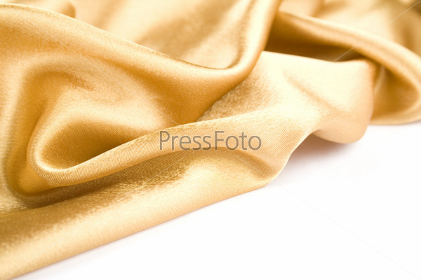 Luxurious gold satin folded cloth, useful for backgrounds. Isolated