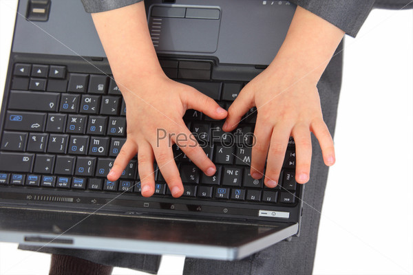 childish Hands on laptop`s keyboard