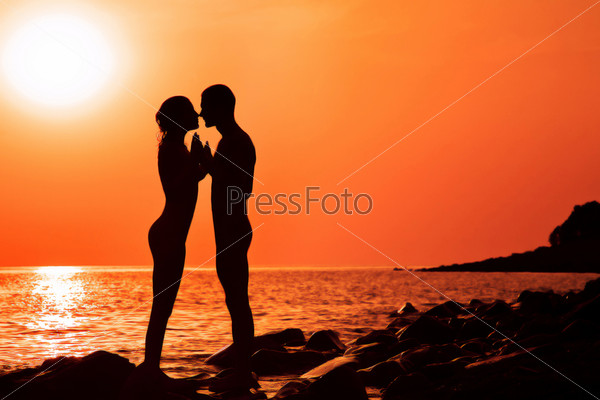 The loving couple on a decline, the sea, shines the sun
