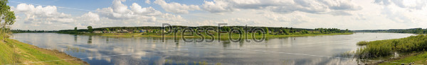 Panorama of a summer landscape with the river,wood and village. River - Suhona - big river in Vologda region (Russia)