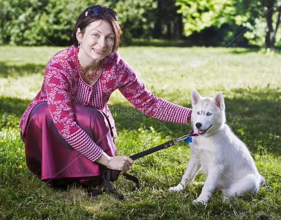 Woman and puppy siberian husky in grass