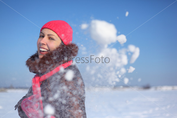young beauty girl outdoor in winter throws snow