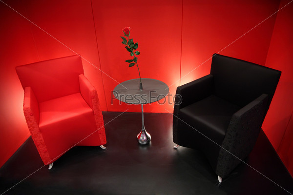 red and black armchairs in red room