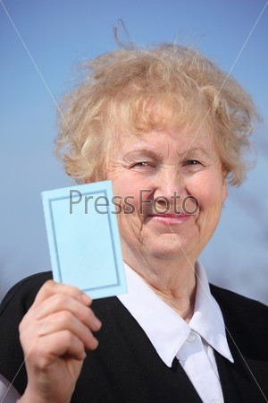 Aged woman holds card in hand