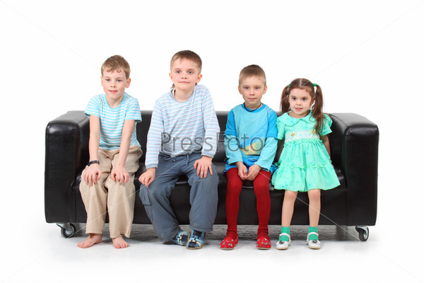 Four children sitting on black leather sofa
