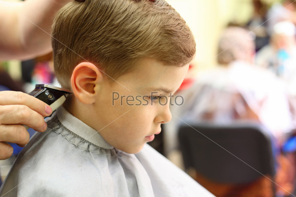 Boy cut in hairdresser\'s machine