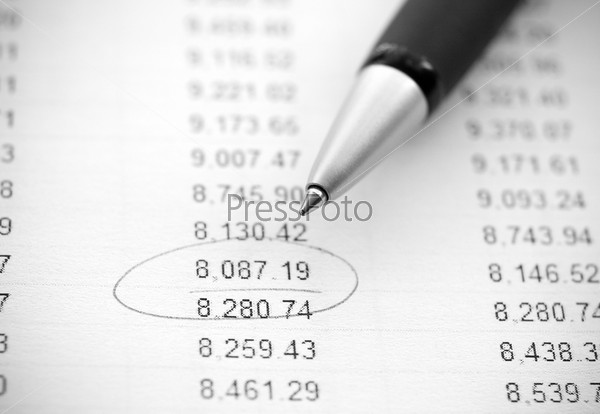 Business still-life: financial report and pen