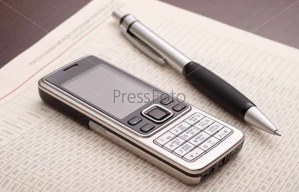 Business still-life: phone, papers and pen