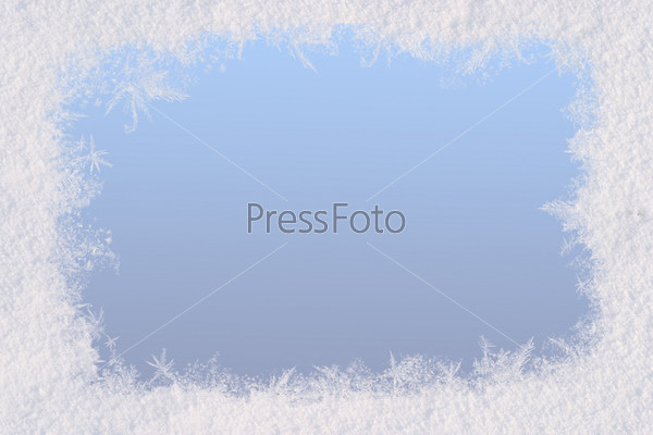 Winter frame for the congratulations. The blue background and natural snow. Space for text