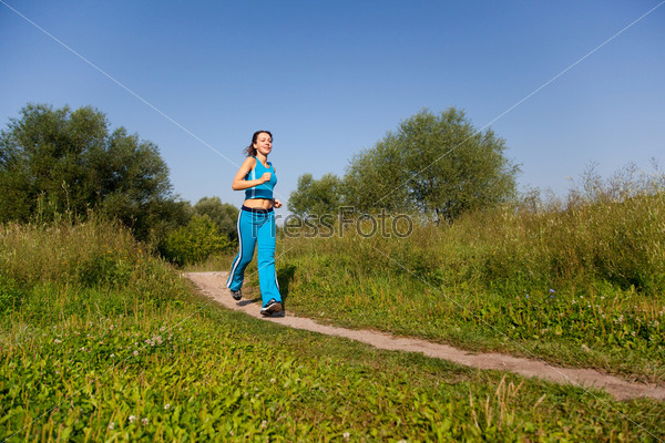 young attractive woman runs in the country