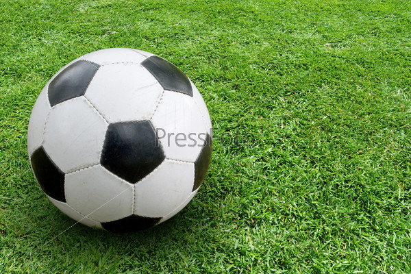 Soccer ball on ground. In the right part of the image space for text
