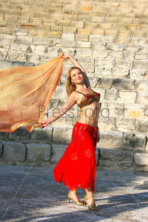 Beautiful belly danceron the ancient stairs of Kourion amphitheatre in Cyprus, stock photo