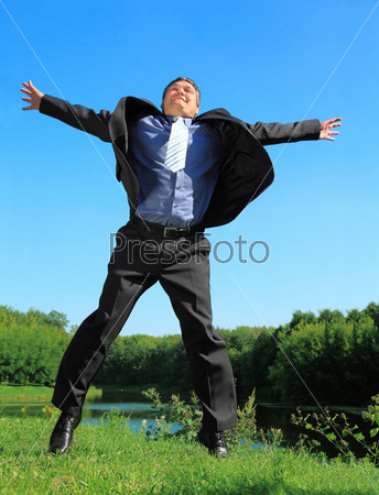 flying businessman outdoor in summer full body