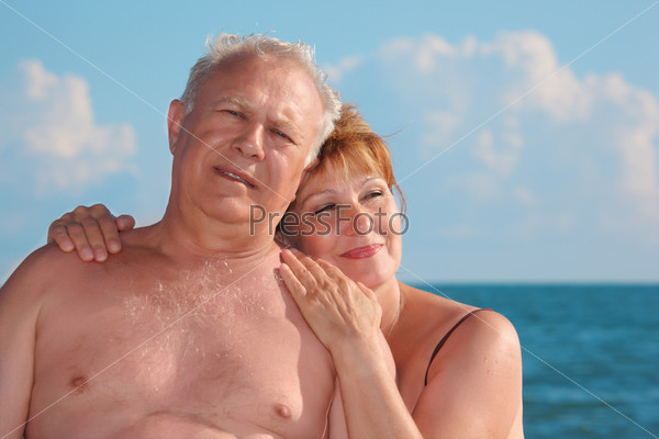 portrait of aged  pair against sea, focus on woman