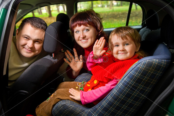 Married couple and  little girl  Greeting to wave hands in car in park