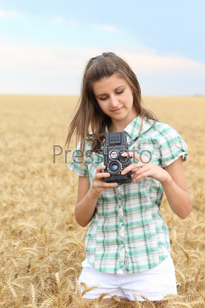 Young girl with vintage camera