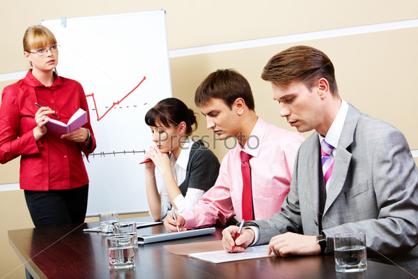 Image of smart teacher looking at students in workshop, stock photo