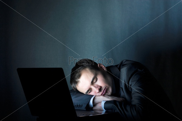 tired businessman sleeping at the computer