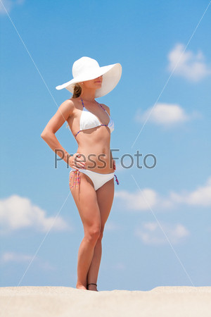 Young woman in white biking enjoying the sun