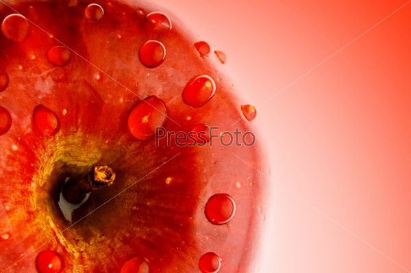 juicy apple isoloated on red background in dewdrop