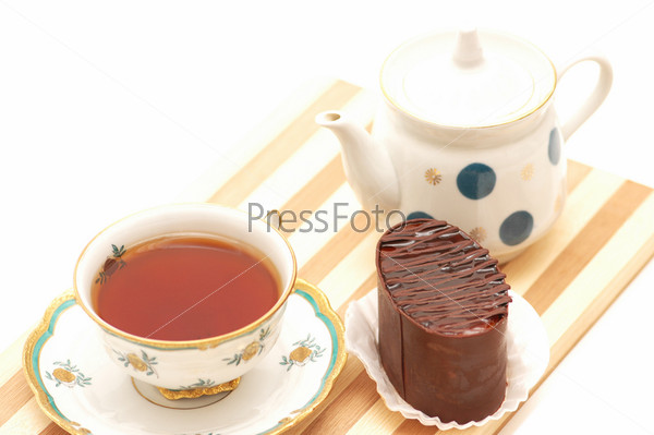 Cup of tea, chocolate cake and pot, stock photo