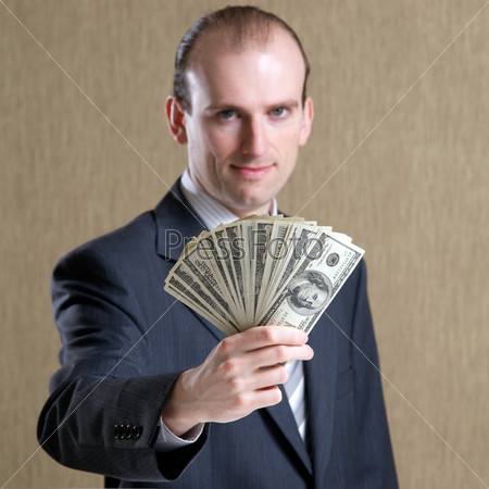 A man holding dollars in his hand