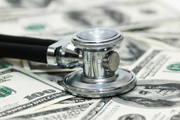 Stethoscope and dollars illustrating expensive healthcare, stock photo